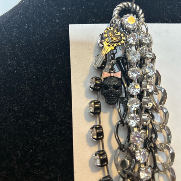 Betsey Johnson Chain/Charm bracelet
Silvertone/black/rhinestones 
Skull Key logo - Picture 3 of 11